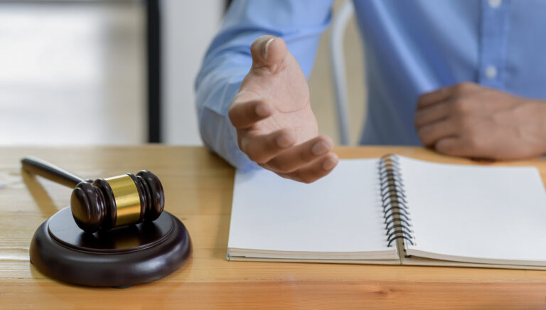 Close-up shot of Hammer on the table and lawyer introducing law, Concept of law.